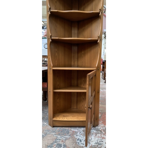 31 - An Ercol Golden Dawn elm free standing corner cabinet - approx. 184cm high