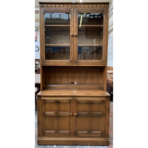 32 - An Ercol Golden Dawn elm display cabinet - approx. 197cm high x 97cm wide x 50cm deep