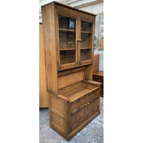 32 - An Ercol Golden Dawn elm display cabinet - approx. 197cm high x 97cm wide x 50cm deep