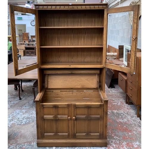 32 - An Ercol Golden Dawn elm display cabinet - approx. 197cm high x 97cm wide x 50cm deep