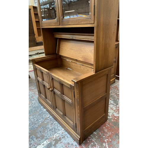 32 - An Ercol Golden Dawn elm display cabinet - approx. 197cm high x 97cm wide x 50cm deep