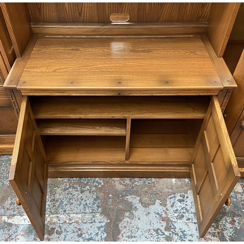 32 - An Ercol Golden Dawn elm display cabinet - approx. 197cm high x 97cm wide x 50cm deep