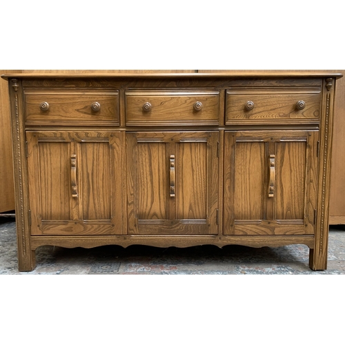 34 - An Ercol Golden Dawn elm sideboard - approx. 86cm high x 143cm wide x 52cm deep