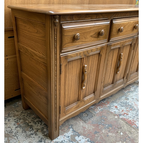 34 - An Ercol Golden Dawn elm sideboard - approx. 86cm high x 143cm wide x 52cm deep