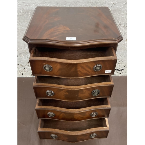 35 - A Regency style mahogany serpentine miniature chest of drawers on bracket supports - approx. 61cm hi... 