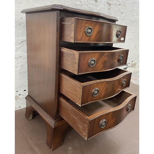 35 - A Regency style mahogany serpentine miniature chest of drawers on bracket supports - approx. 61cm hi... 