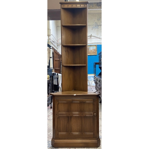 37 - An Ercol Golden Dawn elm free standing corner cabinet - approx. 196cm high