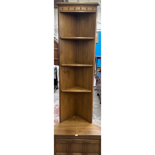 37 - An Ercol Golden Dawn elm free standing corner cabinet - approx. 196cm high