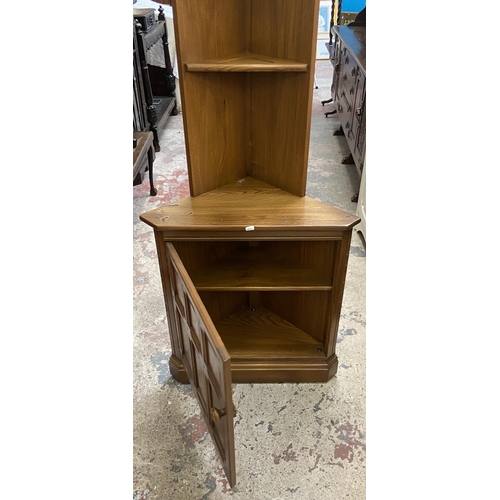 37 - An Ercol Golden Dawn elm free standing corner cabinet - approx. 196cm high