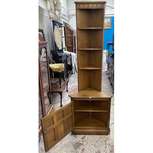 37 - An Ercol Golden Dawn elm free standing corner cabinet - approx. 196cm high