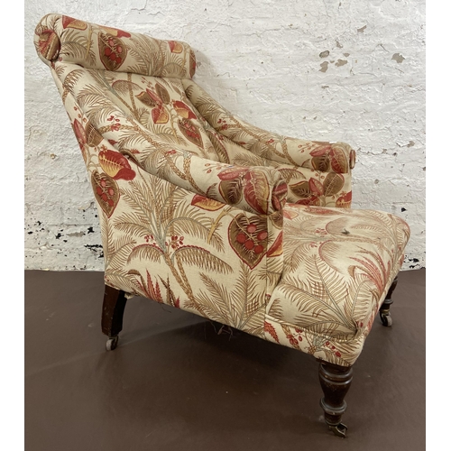 45 - A Victorian Howards style fabric upholstered armchair on mahogany supports and brass castors - appro... 