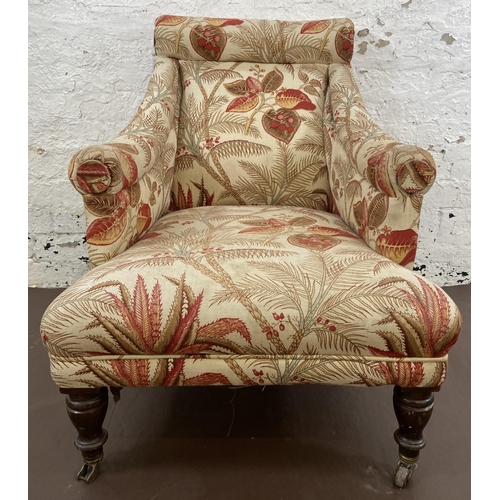 45 - A Victorian Howards style fabric upholstered armchair on mahogany supports and brass castors - appro... 