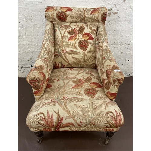 45 - A Victorian Howards style fabric upholstered armchair on mahogany supports and brass castors - appro... 