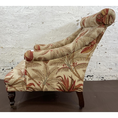 45 - A Victorian Howards style fabric upholstered armchair on mahogany supports and brass castors - appro... 