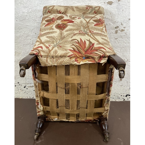 45 - A Victorian Howards style fabric upholstered armchair on mahogany supports and brass castors - appro... 