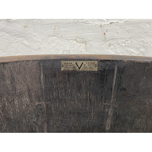 47 - A coopered oak and metal banded planter on wooden stand bearing label 