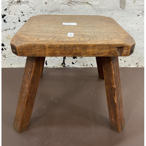 51 - An early 20th century oak farmhouse stool - approx. 25cm high x 26cm wide x 25cm deep