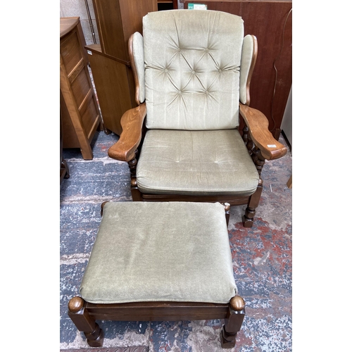 54 - A beech and green fabric button back upholstered armchair and footstool