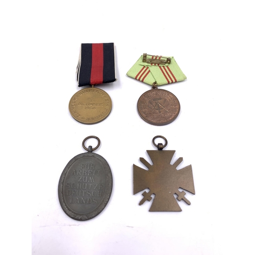 2227 - Four German medals, one III Reich West Wall, one 1938 Commemorative Sudetenland, one For Faithful Se... 