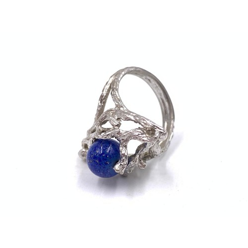 2093 - Two gemstone set rings, one Brutalist style white metal lapis lazuli and one silver chalcedony caboc... 