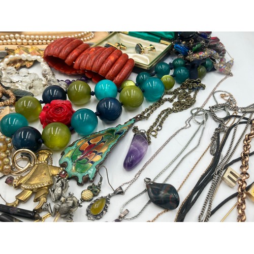 2078 - A large collection of costume jewellery to include .925 silver beeswax amber pendant necklace, coral... 