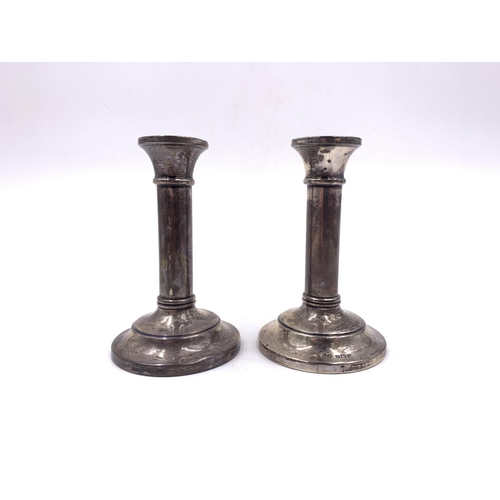 2097 - A pair of George V hallmarked Birmingham silver weighted candlesticks, dated 1922 - approx. 10cm hig... 