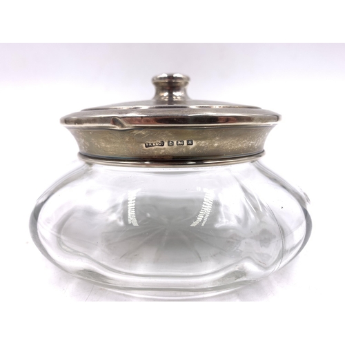 2098 - A glass powder jar with hallmarked Birmingham silver lid, dated 1925 - approx. 13cm diameter