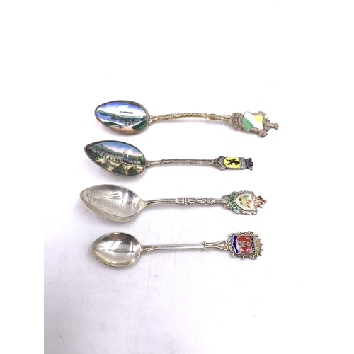 2104 - Seven silver and white metal collector's spoons to include Indian silver, Canadian sterling and enam... 