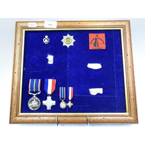 2242 - Seven framed items, one British Anti-Aircraft Command woven cloth patch, one Cheshire Regiment cap b... 