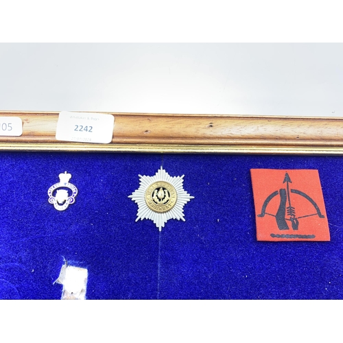 2242 - Seven framed items, one British Anti-Aircraft Command woven cloth patch, one Cheshire Regiment cap b... 