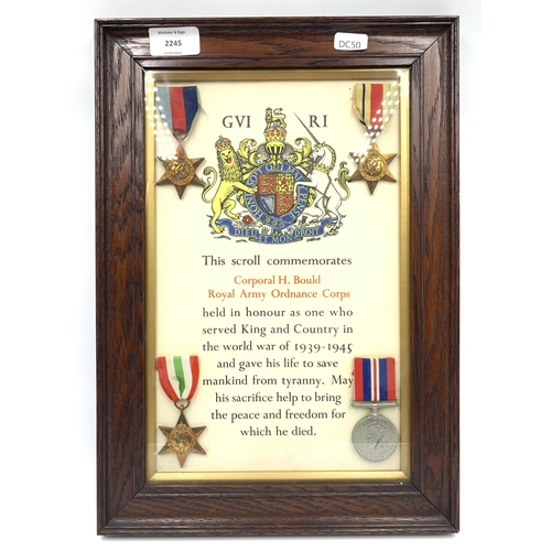 2245 - An oak framed WWII four piece medal group with scroll presented to Corporal H. Bould Royal Army Ordn... 