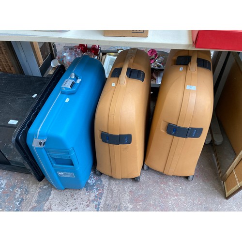 998 - Three hard plastic suitcases, two Samsonite and one American Tourister