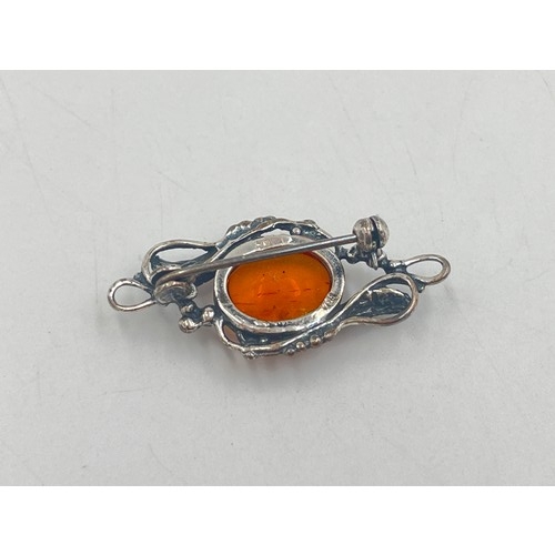 2095A - Three pieces of .925 silver jewellery, one amber pendant necklace, one amber brooch and one filigree... 