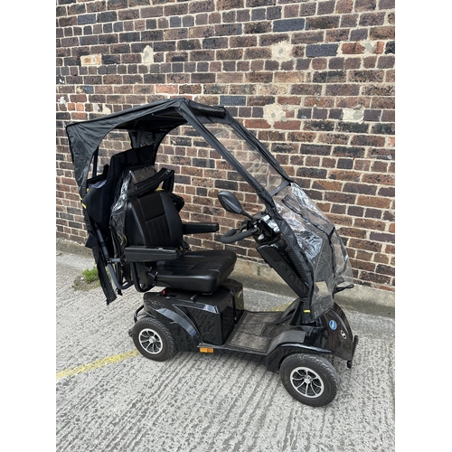 1021 - A Sterling S700 road legal 8mph long range mobility scooter with foldable weather cover