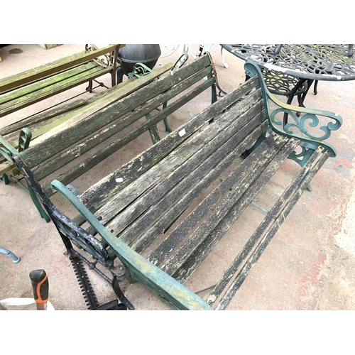 1084 - Two cast iron and wooden slatted garden benches - both approx. 127cm wide x 80cm high