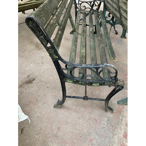 1084 - Two cast iron and wooden slatted garden benches - both approx. 127cm wide x 80cm high