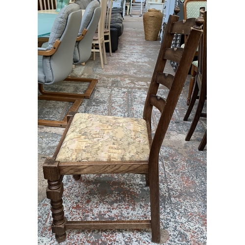 161 - An oak circular extending table on carved baluster support and four chairs - approx. 78cm high x 110... 