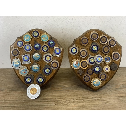 514 - Two vintage carved oak shield frames with a large collection of Macclesfield amateur swimming club m... 