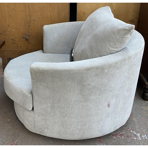 252 - A modern grey fabric upholstered swivel armchair