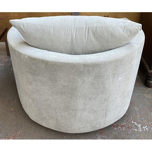 252 - A modern grey fabric upholstered swivel armchair