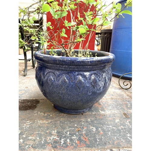 1067 - Two blue glazed planters - largest approx. 36cm high x 50cm diameter