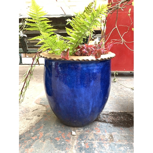 1067 - Two blue glazed planters - largest approx. 36cm high x 50cm diameter