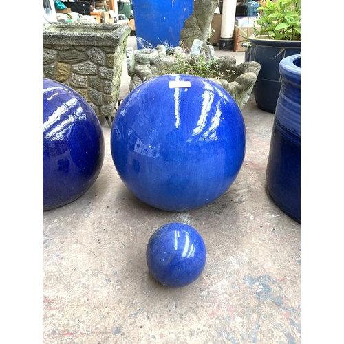 1073 - Two pairs of blue glazed spherical garden ornaments - largest approx. 28cm high