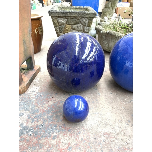 1073 - Two pairs of blue glazed spherical garden ornaments - largest approx. 28cm high