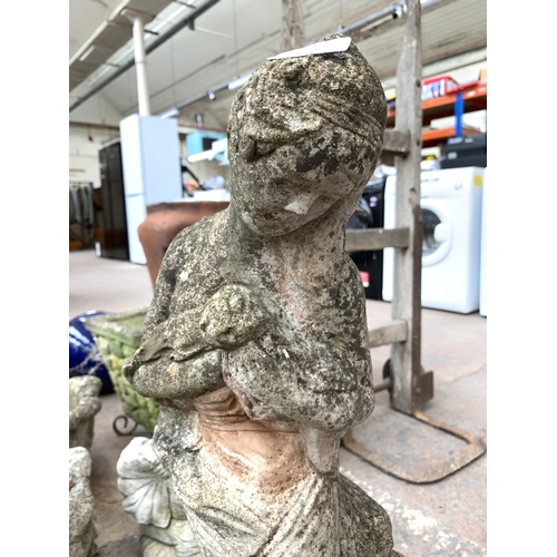 1077 - A cast stone lady garden ornament - approx. 67cm high