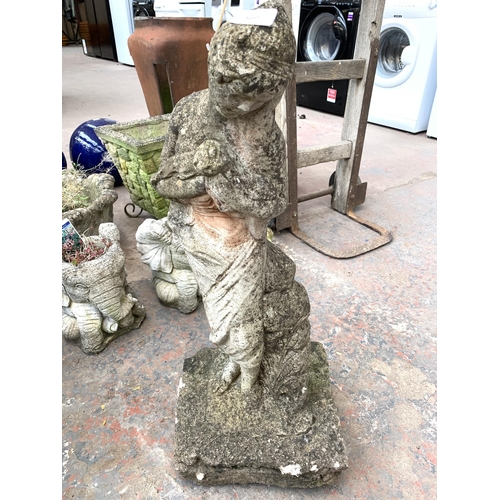 1077 - A cast stone lady garden ornament - approx. 67cm high