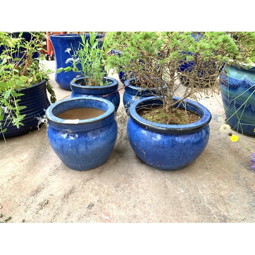 1079 - Four blue glazed garden planters - largest approx. 18cm high x 27cm diameter