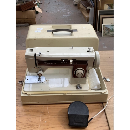 756 - A cased Atlantis model 302 electric sewing machine with boxed accessories and foot pedal