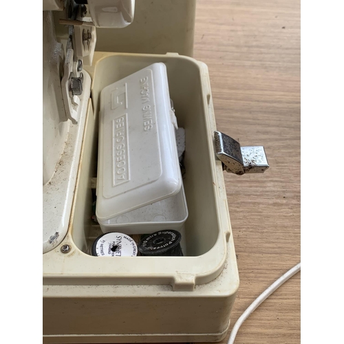 756 - A cased Atlantis model 302 electric sewing machine with boxed accessories and foot pedal