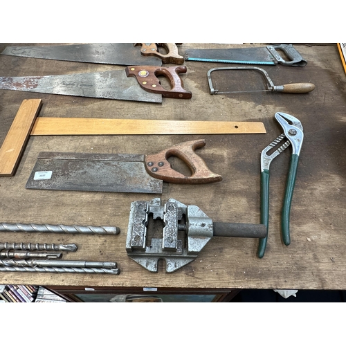 1037 - A collection of vintage tools to include Spear & Jackson hand saws, sharpening stones, M&W micromete... 